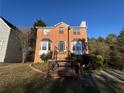 Two-story house with brick facade, wooden deck, and stairs at 5226 Oaktree Trl, Lithonia, GA 30038