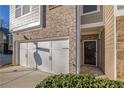 Dark brown front door entry to townhome with brick facade at , Stone Mountain, GA 30083