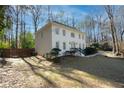 Side view of a two-story brick home with a large yard and wooden fence at 1080 Willow Bnd, Roswell, GA 30075