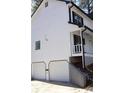 Two-car garage with white doors and a concrete driveway at 205 Hardman Way, Woodstock, GA 30188