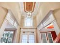 Elegant foyer showcases high ceilings, a decorative light fixture, and an arched transom window at 2602 Alcovy Club Dr, Dacula, GA 30019