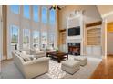 Spacious living room features tall windows, fireplace, and built-in bookshelves at 2602 Alcovy Club Dr, Dacula, GA 30019