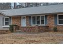 Brick front porch with gray roof and blue shutters at 2925 Fern Valley Sw Dr, Marietta, GA 30008