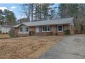 Brick ranch house with gray roof, landscaping, and a driveway at 2925 Fern Valley Sw Dr, Marietta, GA 30008