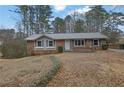 Brick ranch house with gray roof, landscaping, and a driveway at 2925 Fern Valley Sw Dr, Marietta, GA 30008