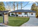 Updated ranch home showcasing a stylish front entry and well-maintained lawn at 1573 Newton Se Ave, Atlanta, GA 30316