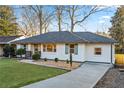 Charming ranch home with newly paved driveway and manicured lawn at 1573 Newton Se Ave, Atlanta, GA 30316