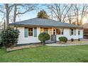 Recently renovated ranch house featuring a fresh coat of paint and lush landscaping at 1573 Newton Se Ave, Atlanta, GA 30316