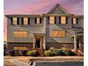 Inviting townhouse exterior with warm sunset lighting and manicured landscaping at 3898 High Dove Sw Way # 12, Smyrna, GA 30082