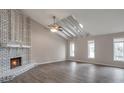 High-ceilinged living room with fireplace and wood-look floors at 2599 Fieldstone View Se Ln, Conyers, GA 30013