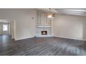 Spacious living room with fireplace and wood-look floors at 2599 Fieldstone View Se Ln, Conyers, GA 30013