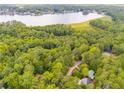 Scenic aerial view of a lake community with lush green trees and charming homes at 10213 Tall Pine, Villa Rica, GA 30180