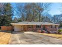 Front view of brick ranch house with driveway at 1171 Larch Ln, Decatur, GA 30033