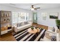 Virtually staged living room with hardwood floors and a neutral color scheme at 1048 Plainview Dr, Marietta, GA 30066