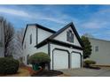 White two-story house with a two-car garage and landscaping at 2587 Alvecot Cir, Atlanta, GA 30339