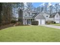 Two-story house with gray siding, two-car garage, and a large yard at 2915 Saint Andrews Ct, Cumming, GA 30041