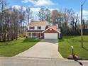 Two-story house with a spacious yard and attached garage at 4496 Whitt Station Nw Run, Acworth, GA 30101