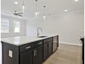 Modern kitchen with a large island, stainless steel appliances, and white cabinetry at 713 Trevett Way, Marietta, GA 30062