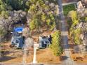 Aerial view showcasing a home near other properties, featuring a swimming pool and convenient access to the main road at 10 Lindsey Ct, Mcdonough, GA 30252