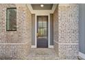 Inviting front door entry with stylish brick details offering a warm welcome at 116 Cottage Gate Ln, Roswell, GA 30076