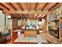 Spacious living room features a rustic stone fireplace and hardwood floors at 305 Carrolls Way, Fayetteville, GA 30215