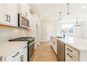 White kitchen with stainless steel appliances and an island at 701 Trevett Way, Marietta, GA 30062