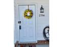 White front door adorned with a sunflower wreath, showcasing curb appeal at 2786 Laurel Ridge Cir, East Point, GA 30344