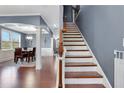 Wooden staircase with white risers and a gray wall at 406 Providence Walk St, Canton, GA 30114