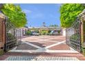 Gated entrance to a beautiful bricked circular driveway with lush landscaping at 5200 Moore Rd, Suwanee, GA 30024
