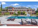 Stunning backyard pool with lounge seating, with the brick mansion as the backdrop at 5200 Moore Rd, Suwanee, GA 30024