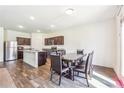 Eat-in kitchen with stainless steel appliances, granite counters and wood flooring at 7247 Emma Ct, Douglasville, GA 30134