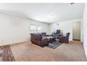 Open-concept living area featuring neutral tones and a decorative rug at 7247 Emma Ct, Douglasville, GA 30134