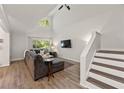 Spacious living room with vaulted ceiling, hardwood floors and a large sectional sofa at 2479 Cedar Canyon Se Rd # 2479, Marietta, GA 30067