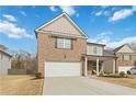 Two-story brick home with a front porch and attached garage at 5010 Ethans Cove Dr, Austell, GA 30106