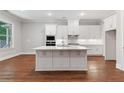 White kitchen island with quartz countertop and stainless steel appliances at 228 Trecastle Sq # 24, Canton, GA 30114
