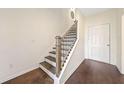 Modern staircase with dark wood treads and black metal balusters at 3075 Westpoint Cir, Snellville, GA 30078