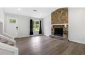 Living room with hardwood floors, fireplace, and access to backyard at 6231 Creekford Dr, Lithonia, GA 30058