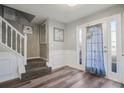 Bright entryway with staircase, wood-look floors, and white trim at 1762 Wood Stork Dr, Hampton, GA 30228