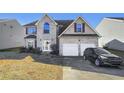 Two-story brick home, two-car garage, front yard at 1762 Wood Stork Dr, Hampton, GA 30228
