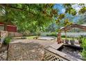 Serene backyard featuring a custom-built patio, gazebo, mature trees, and a fish pond at 930 Custer St, Atlanta, GA 30354