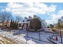 Charming two-story home with a blue exterior, an inviting front porch, and a black metal fence at 930 Custer St, Atlanta, GA 30354