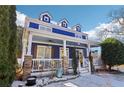 Charming two-story home with a blue exterior, an inviting front porch with stone pillars at 930 Custer St, Atlanta, GA 30354
