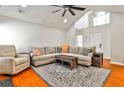 Bright living room features a vaulted ceiling, hardwood floors and neutral decor at 320 Windermere Dr, Loganville, GA 30052