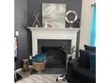 Modern fireplace with decorative mantle and artwork at 5680 Cascade Sw Run, Atlanta, GA 30336