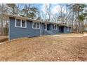 Ranch style home features a newly painted gray brick exterior, updated landscaping, and a curved walkway at 4145 White Oak Dr, Winston, GA 30187