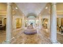 Two-story foyer with grand columns and marble flooring at 4787 Northside Dr, Atlanta, GA 30327