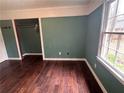 Bedroom featuring hardwood floors, a closet and a large window letting in natural light at 54 Cross Branches, Acworth, GA 30101