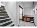 Hallway featuring a staircase, tile flooring, and a small cabinet at 54 Cross Branches, Acworth, GA 30101