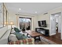 Inviting living room with balcony access and a contemporary entertainment center at 395 Pharr Ne Rd # 207, Atlanta, GA 30305