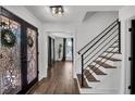 Bright foyer features hardwood floors, a modern staircase, and decorative glass front door at 7110 Brandon Mill, Sandy Springs, GA 30328